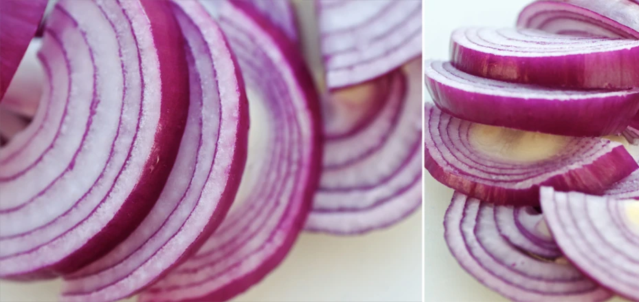 sliced red onions on a  board next to each other