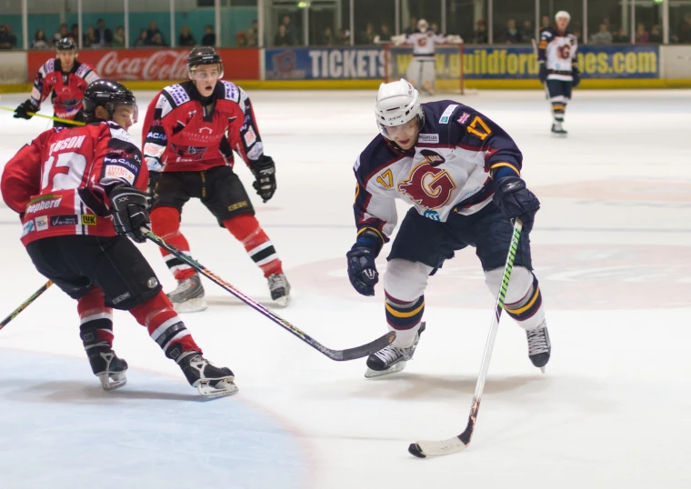 young men playing hockey in front of an audience