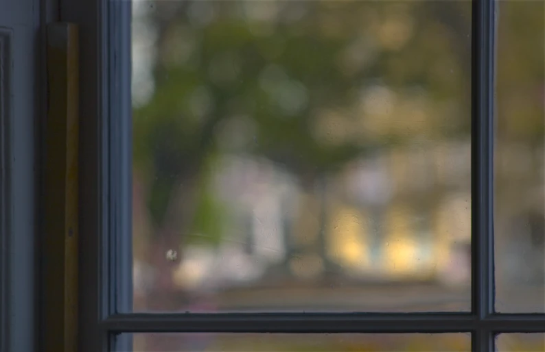 a red phone sitting on the side of a window