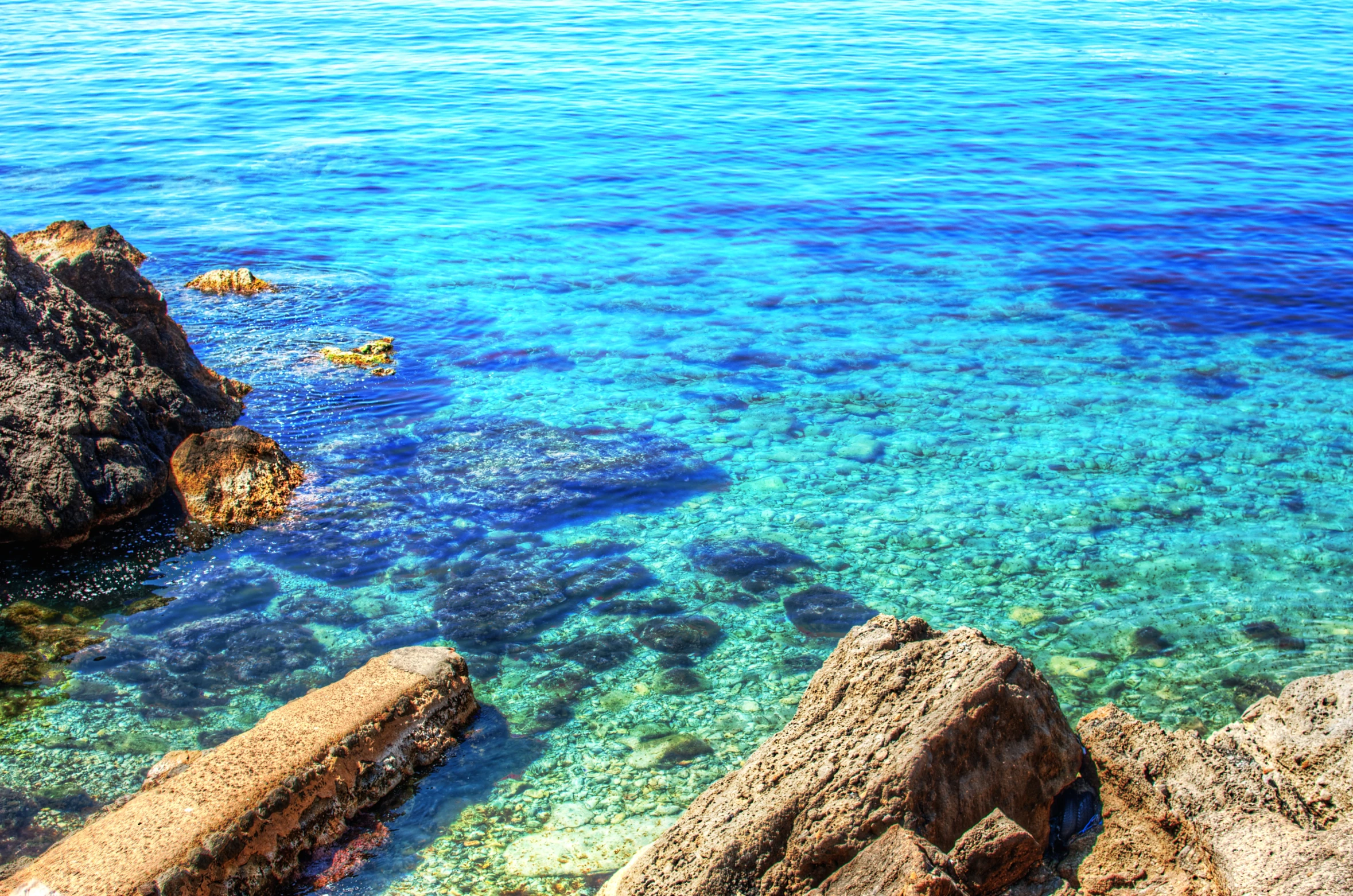 a beautiful ocean scene with water and rocks