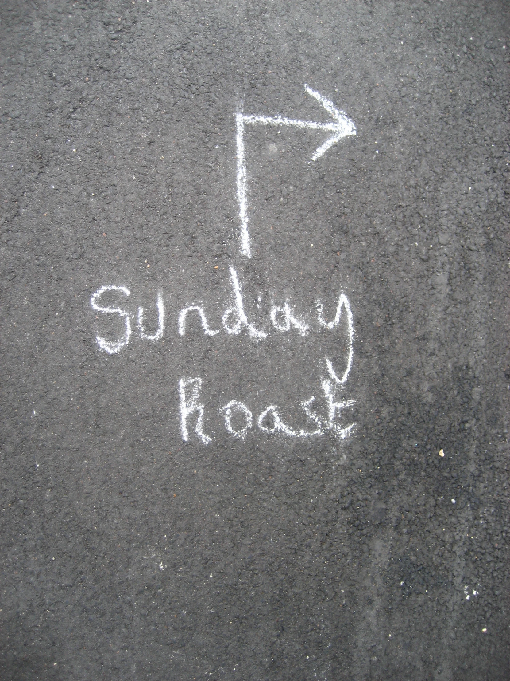 sidewalk writing on asphalt that says sunday roast