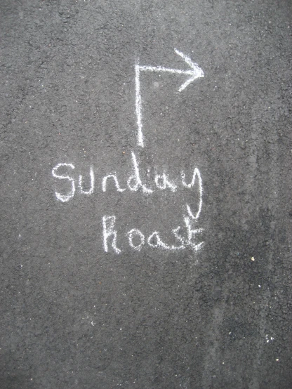 sidewalk writing on asphalt that says sunday roast