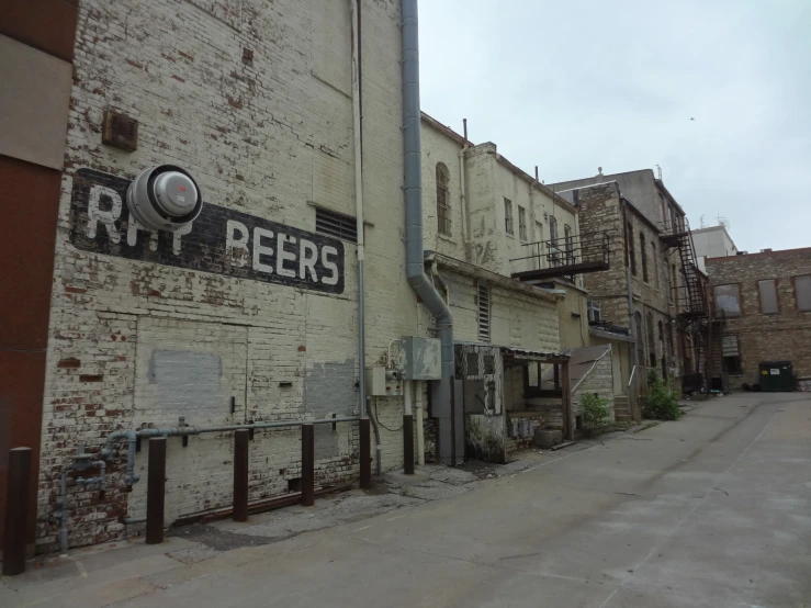 an old building has a road sign on it