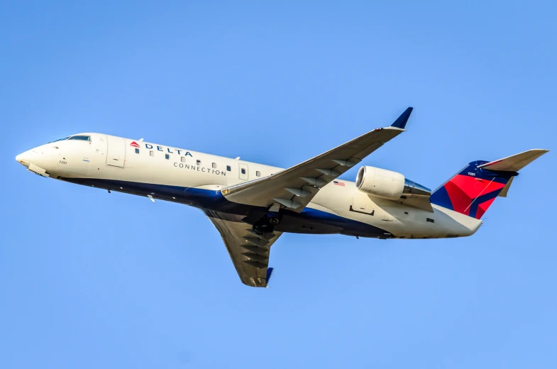 an airplane in the air with its landing gear extended