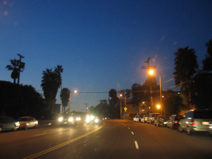 cars going down a busy street in the evening