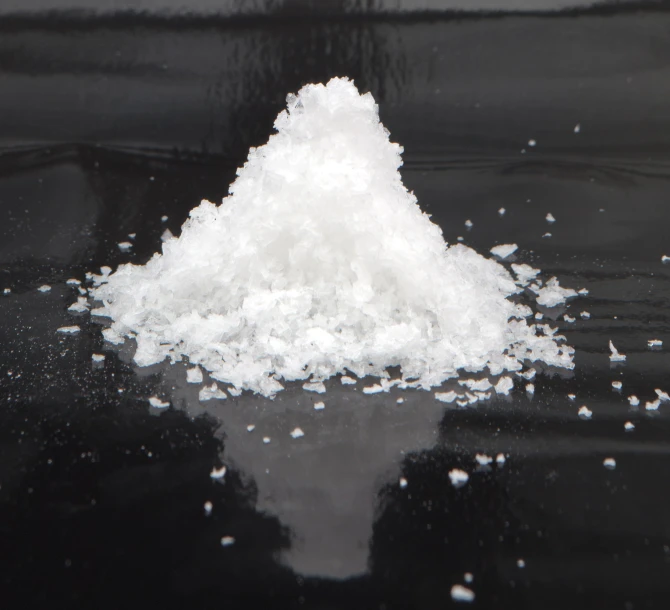 a pile of sugar sits on top of some water