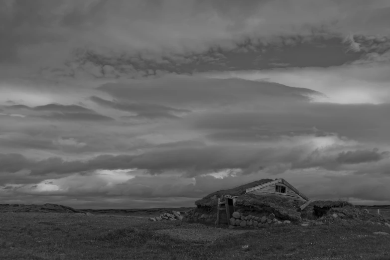 a black and white po of a old building with a barn on top