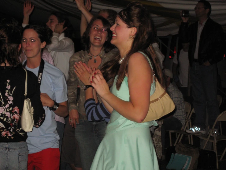 a group of people clapping in front of a crowd