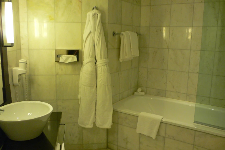 a bathroom with white tile and a tub