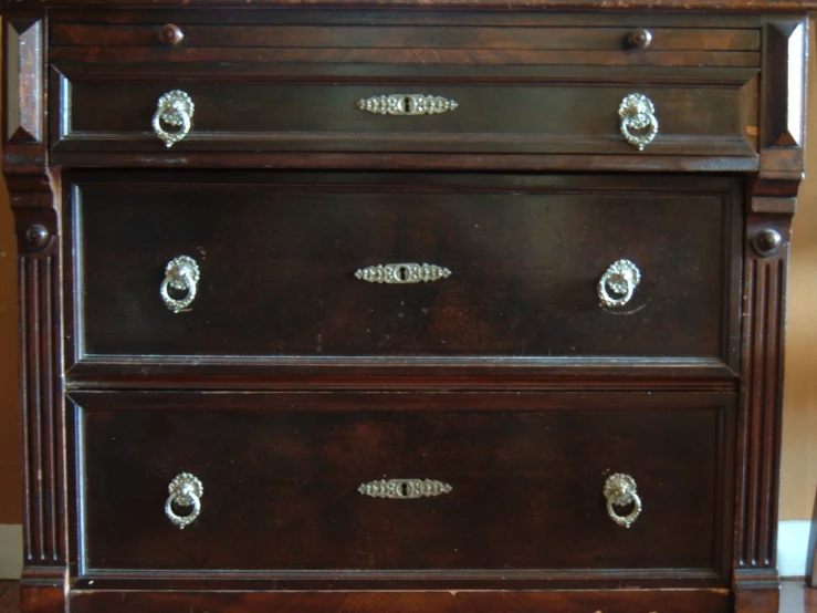 an old dresser with ss s and handles