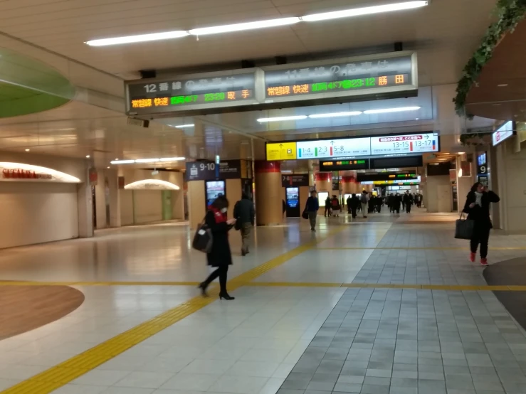 a subway station with several people walking by