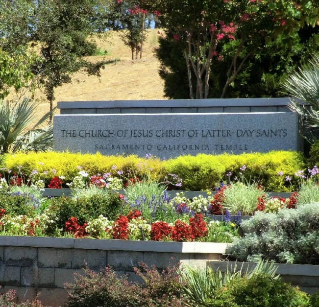 the church of st anthony's memorial sign and flowerbed