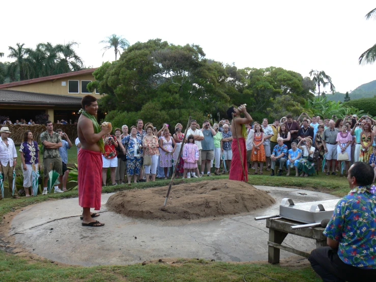 some people are watching two men put soing in a round