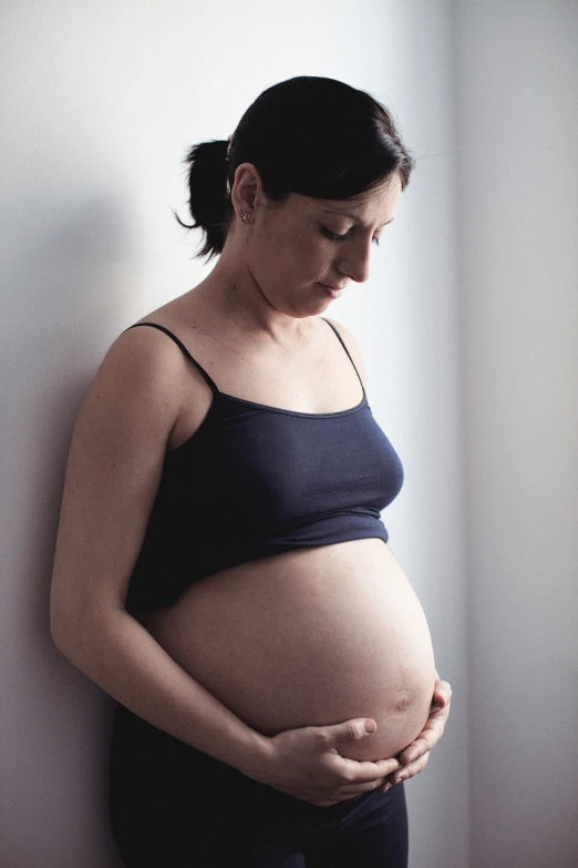 the pregnant woman is wearing a dark top