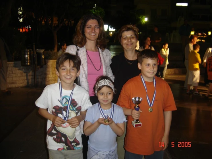 some s standing with their medals on each of them