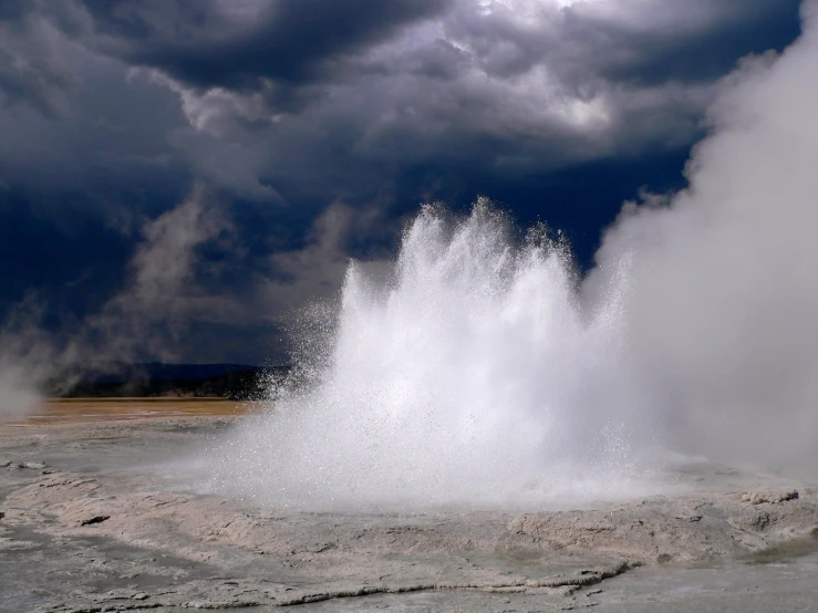 there is water splashing out of the  and spraying down the ground