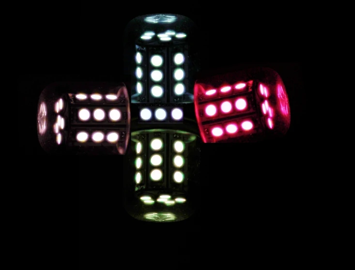 four lights in the shape of a cross on a black background