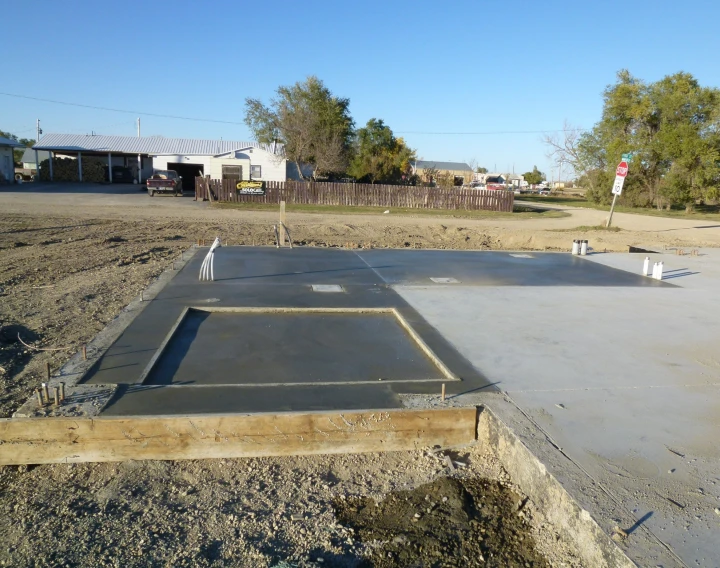 a construction site with a cement slab under it