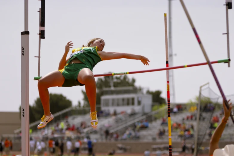 woman on a high jump with spectators watching