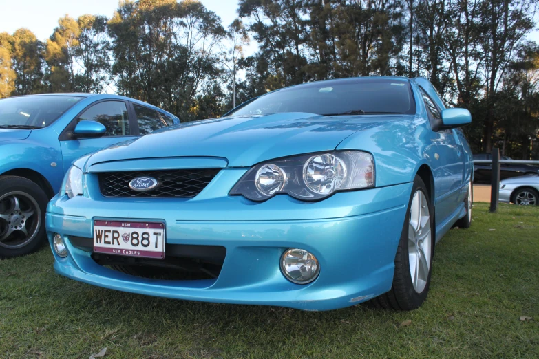 the front and side of a car that is blue