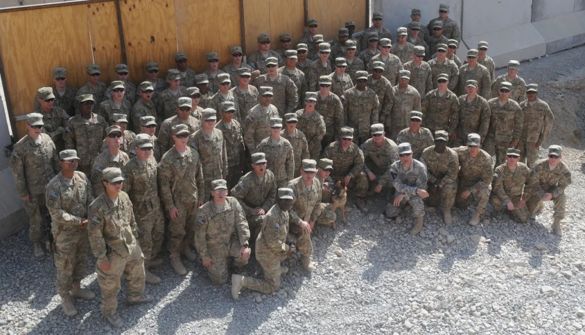 a large group of soldiers and civilians posing together