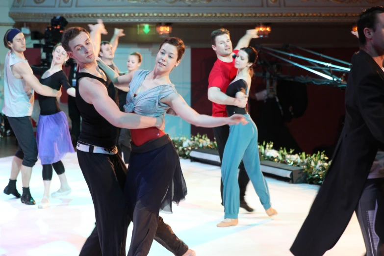 dancers performing in costume on ice rink in city