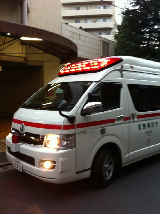 an ambulance parked in front of a building with red lights