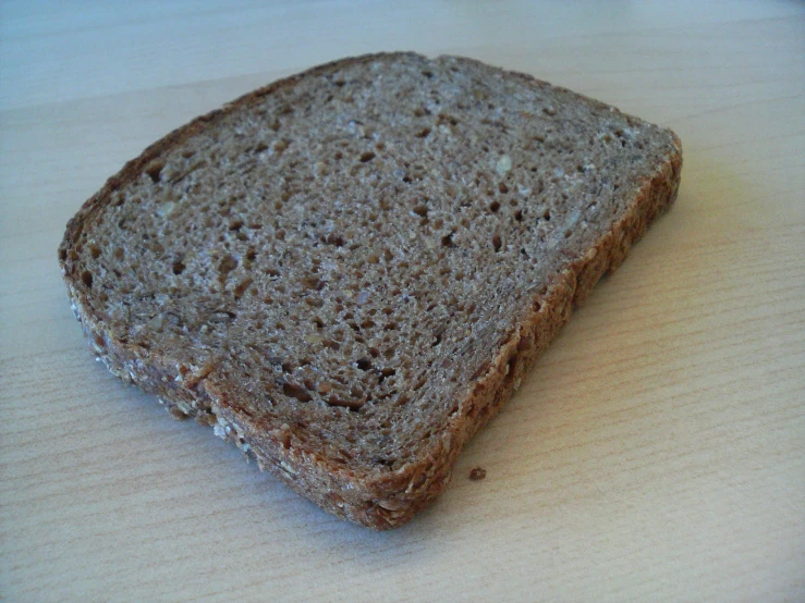 a very big slice of bread sitting on a table