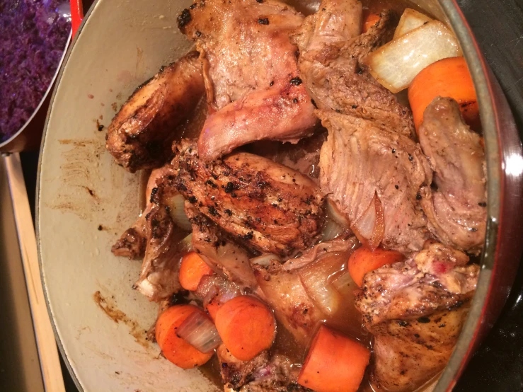 a dish of meat and vegetables with carrots