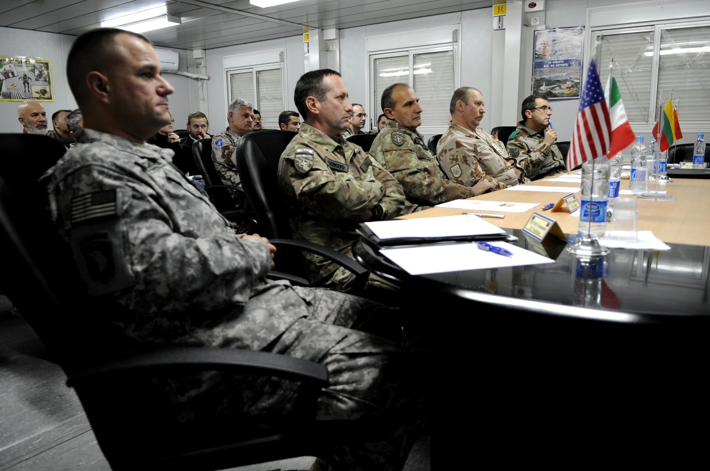 soldiers are sitting at the head of a table