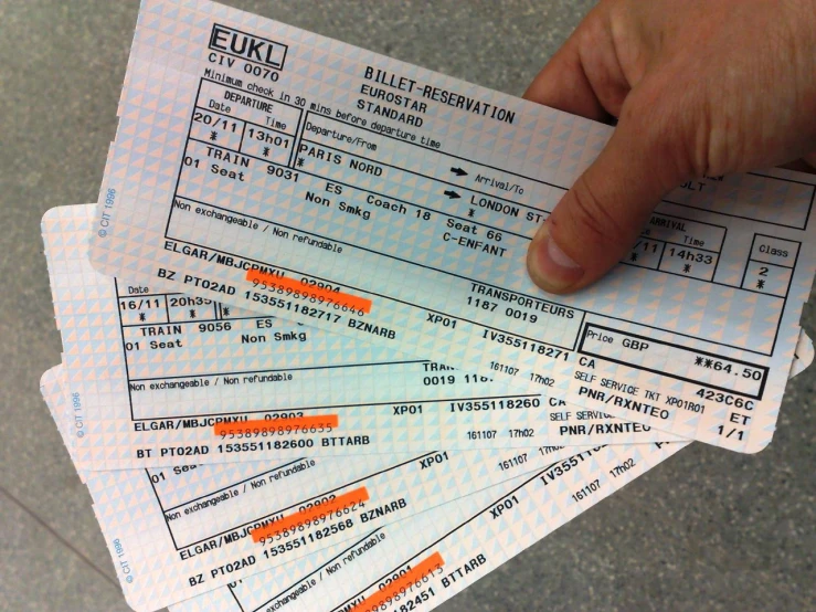 four passenger passes being held together in a hand