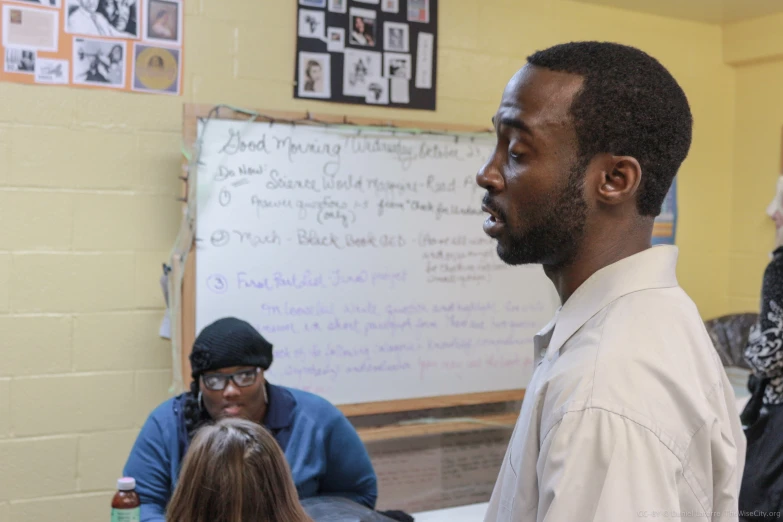 a black man standing in front of a group of people