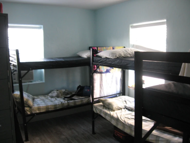 bunk beds in a bedroom with two windows