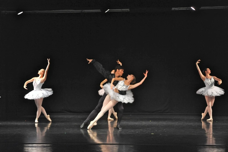 ballet students in black and white costumes performing