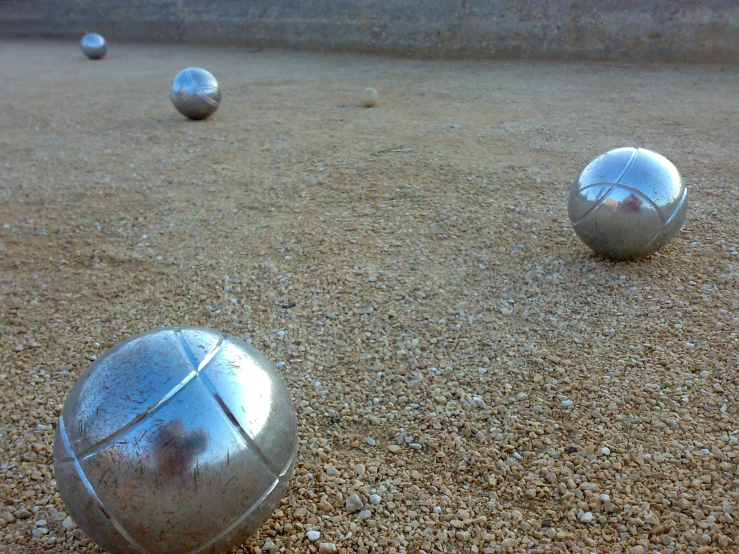some metal balls are laying on the ground