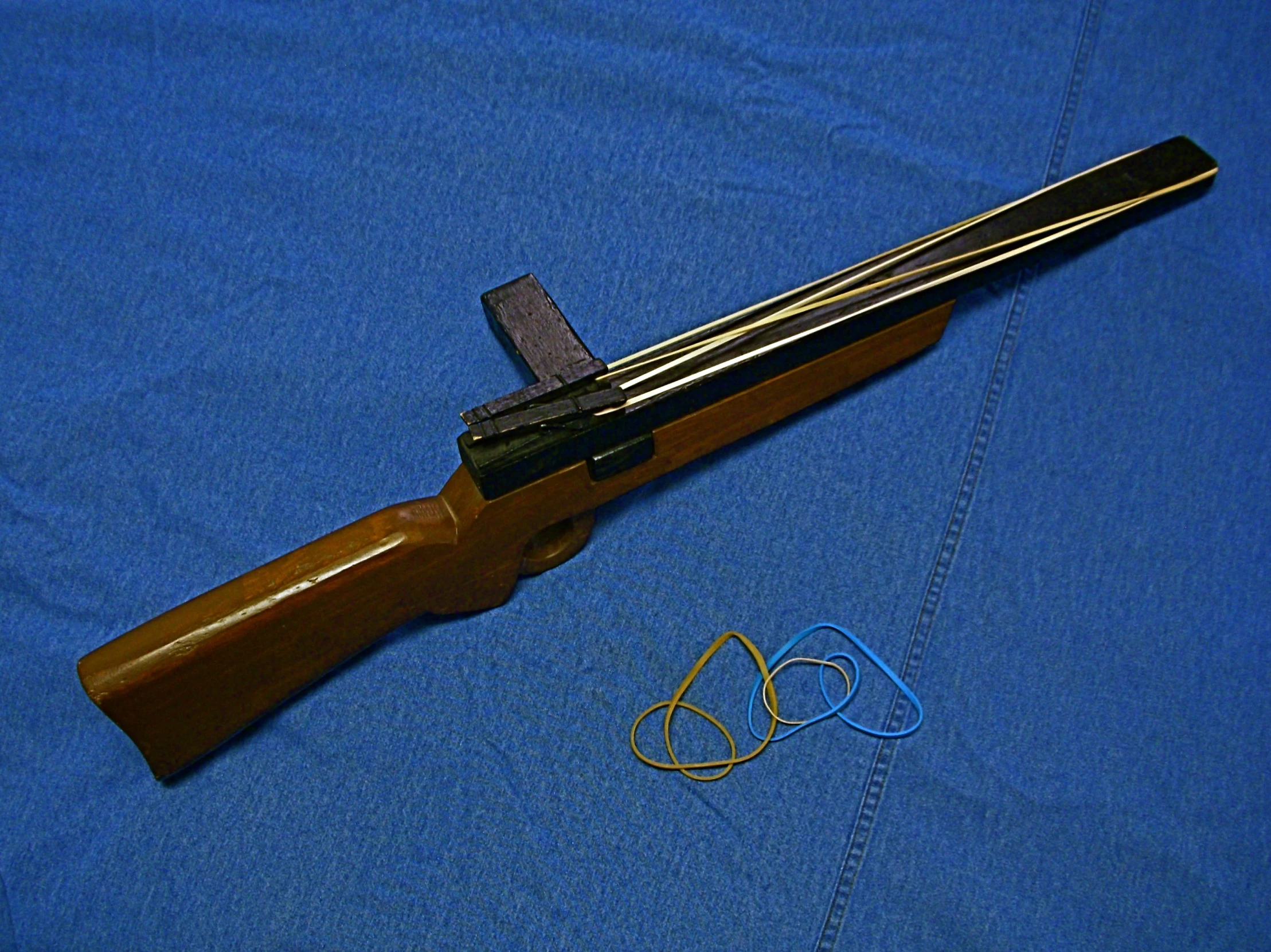 the blue - faced rifle is laying beside a pair of glasses