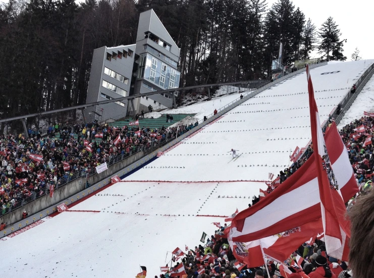 a person riding skis on top of a snow covered slope