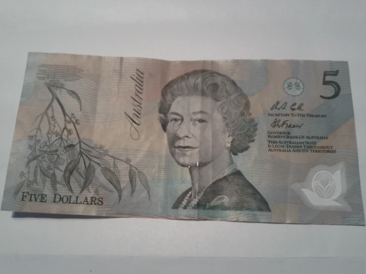 a five dollars bill with the queen of england on it