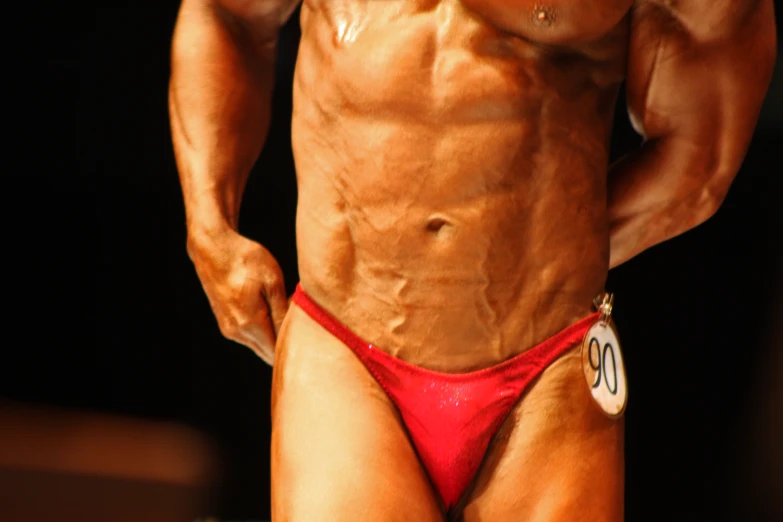a man wearing a red bikini posing for the camera