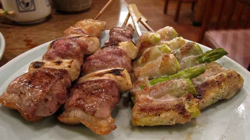 many skewers of food sit on a plate