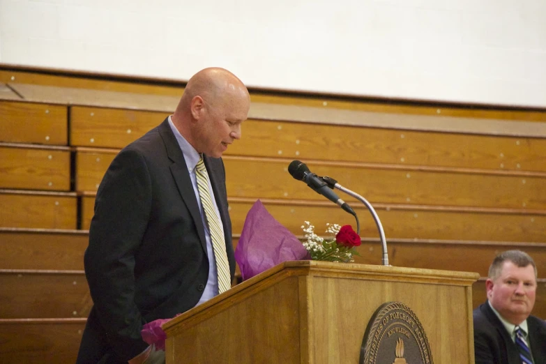 a man speaking from behind a podium in a courtroom