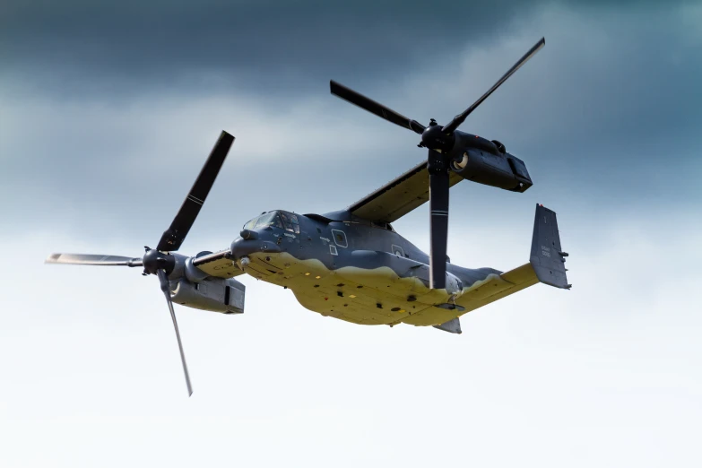 a military helicopter flying in the sky