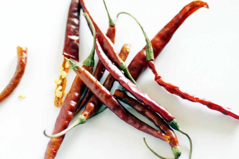 the red and yellow dried carrots are next to the green beans