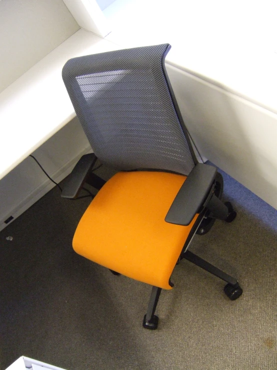 an office chair sitting next to a computer monitor