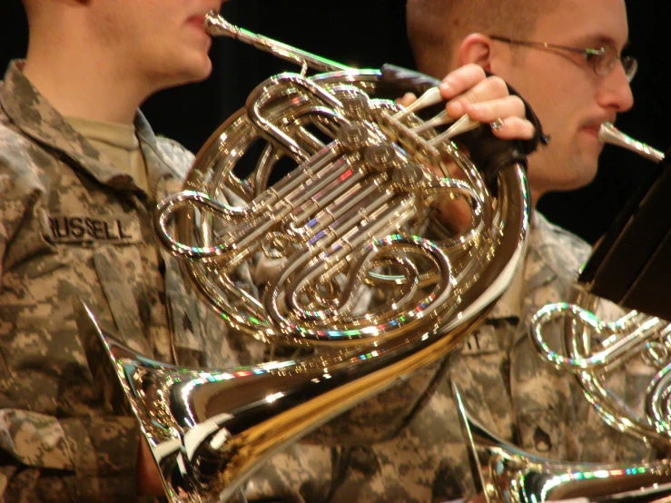 two soldiers playing the instrument at a military function