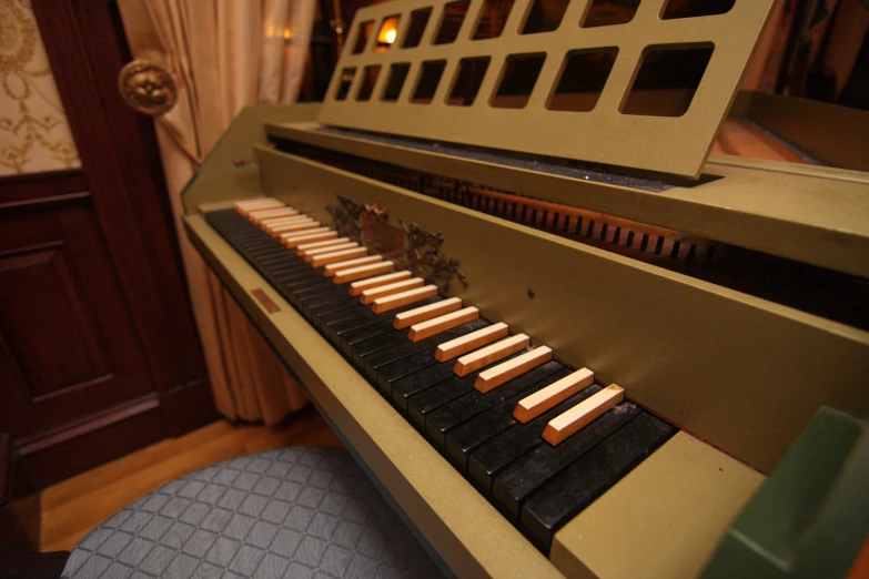 an old fashioned piano sitting in front of a large door