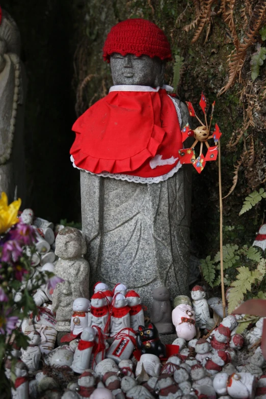 an image of a statue with a red hat and red dress