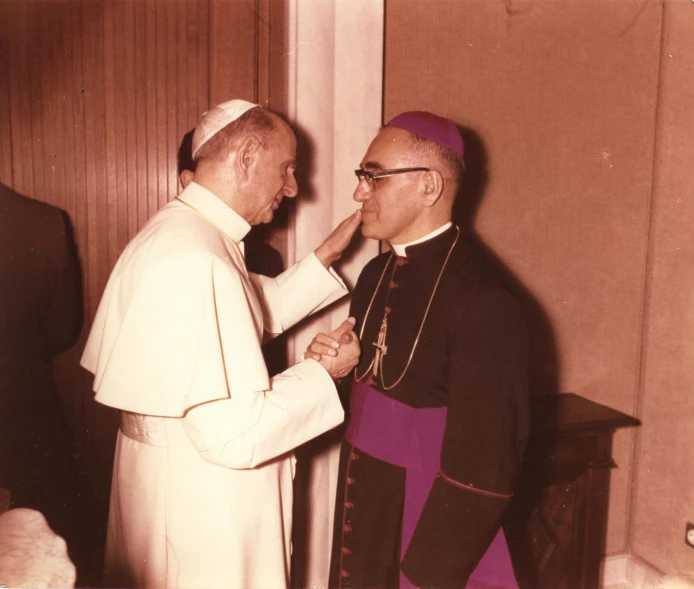 two men shake hands on a table