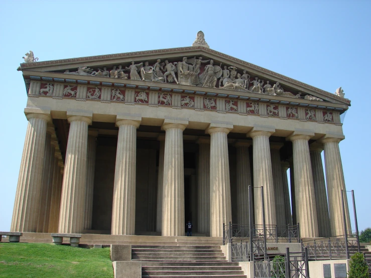 statues in front of the large buildings of this building