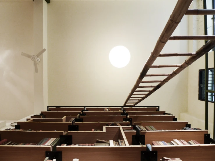 a liry with rows of desks and a ladder